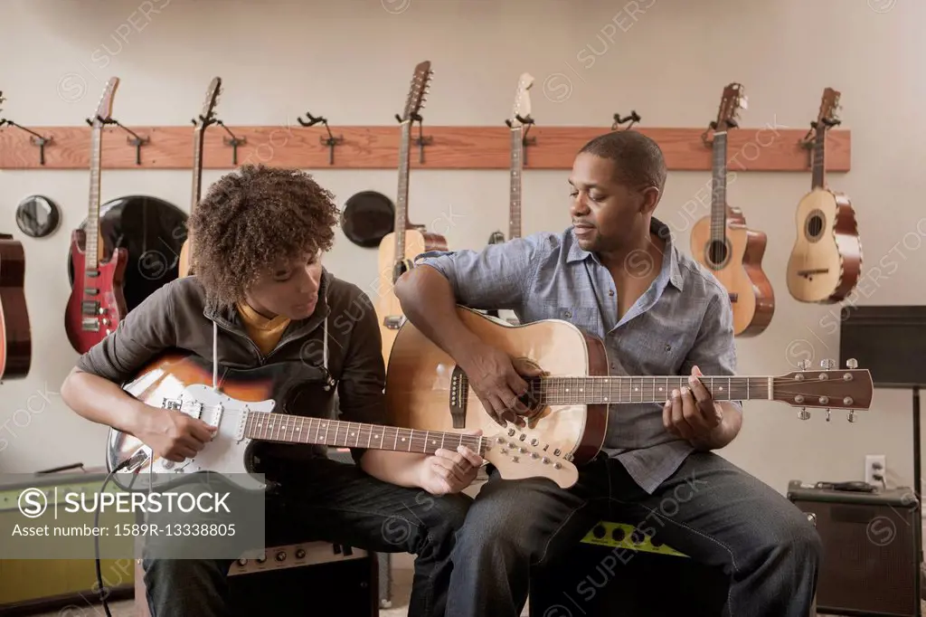 Father and son playing guitars together