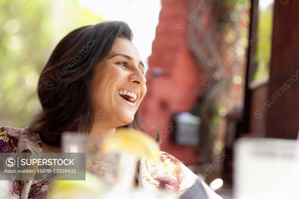 Smiling Hispanic woman in restaurant