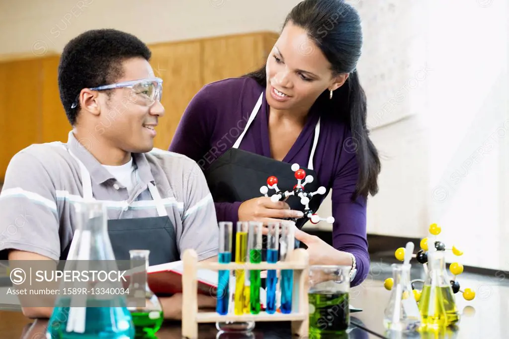 Teacher and student working with chemicals in classroom