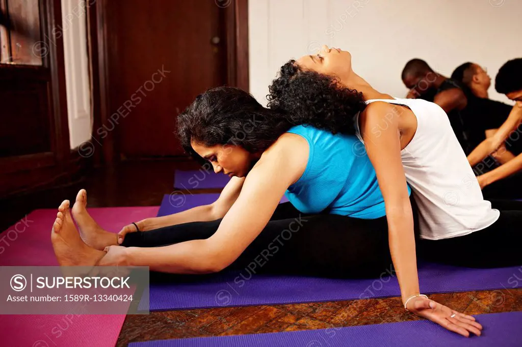 Women stretching together in yoga class