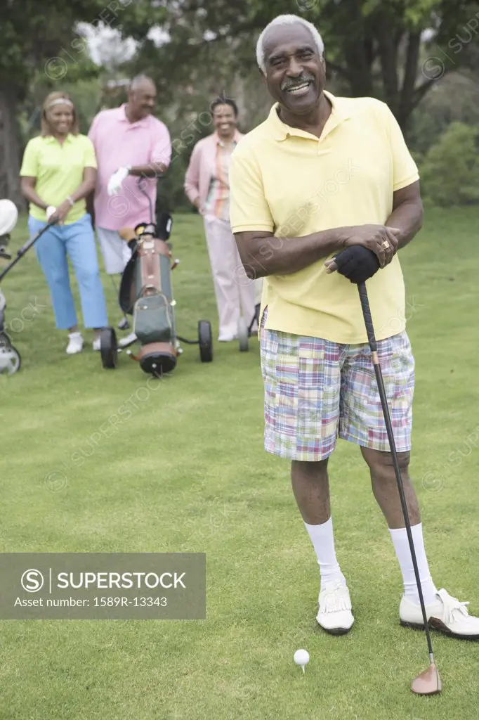 Senior man posing with golf club