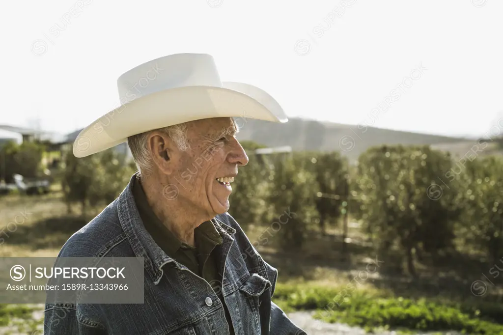 Hispanic farmer smiling in vineyard
