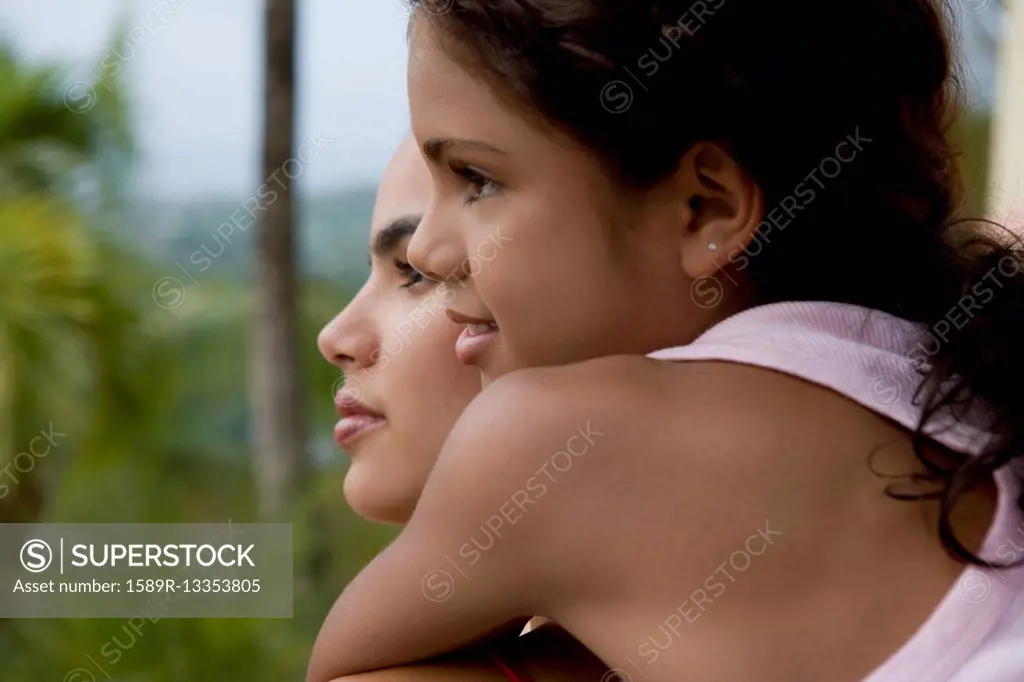 Hispanic girl hugging sister