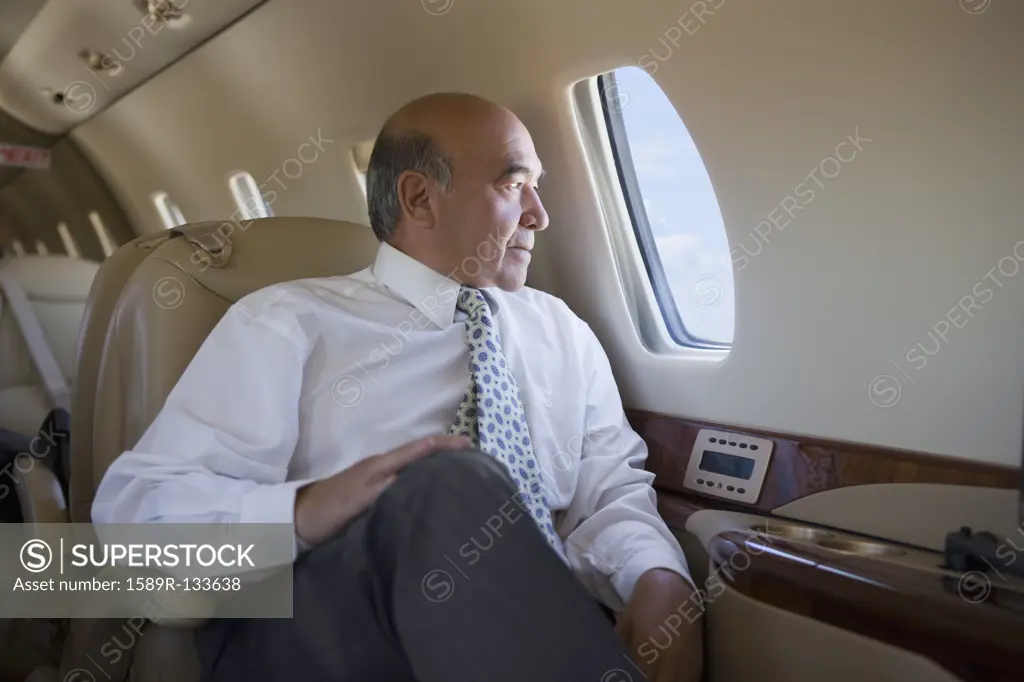 Hispanic businessman on private jet