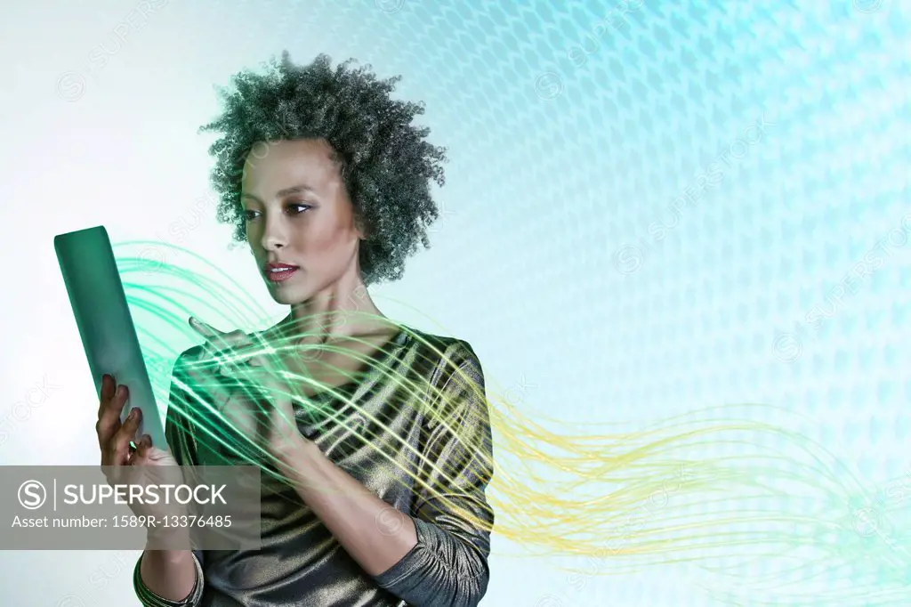 Mixed race businesswoman using digital tablet