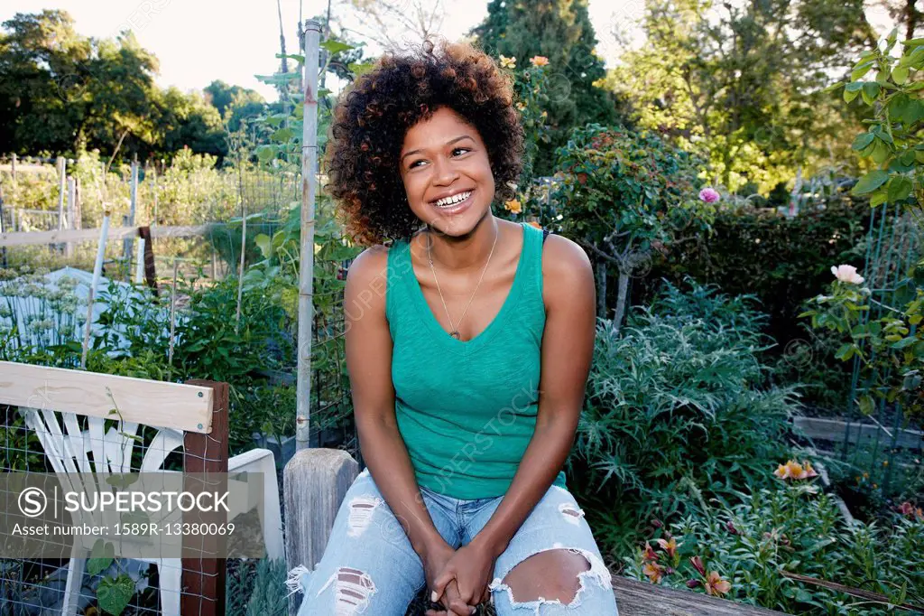 Mixed race woman sitting in garden