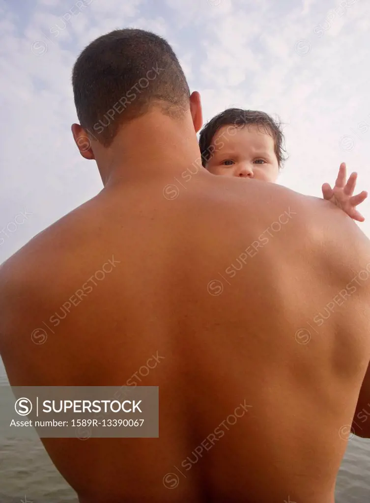 Mixed Race father holding baby
