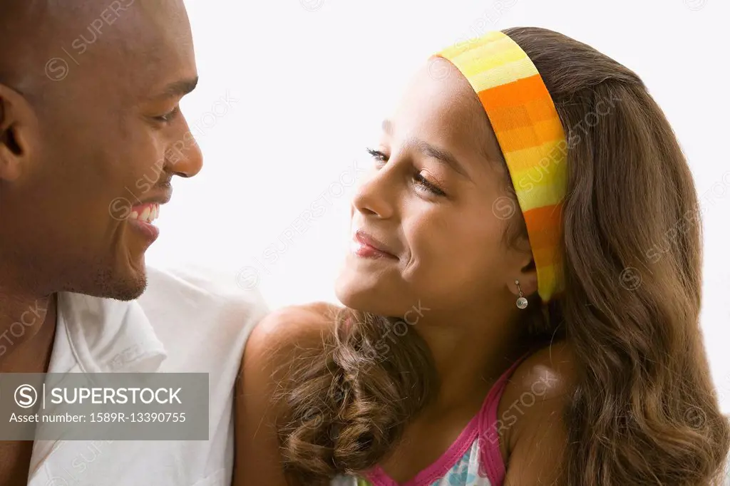 Mixed race girl smiling at father