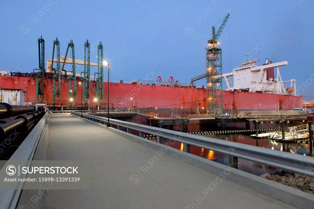 Concrete walkway to container ship in shipyard
