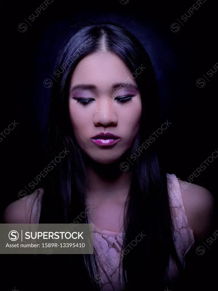 Close up of Chinese woman with long hair looking down
