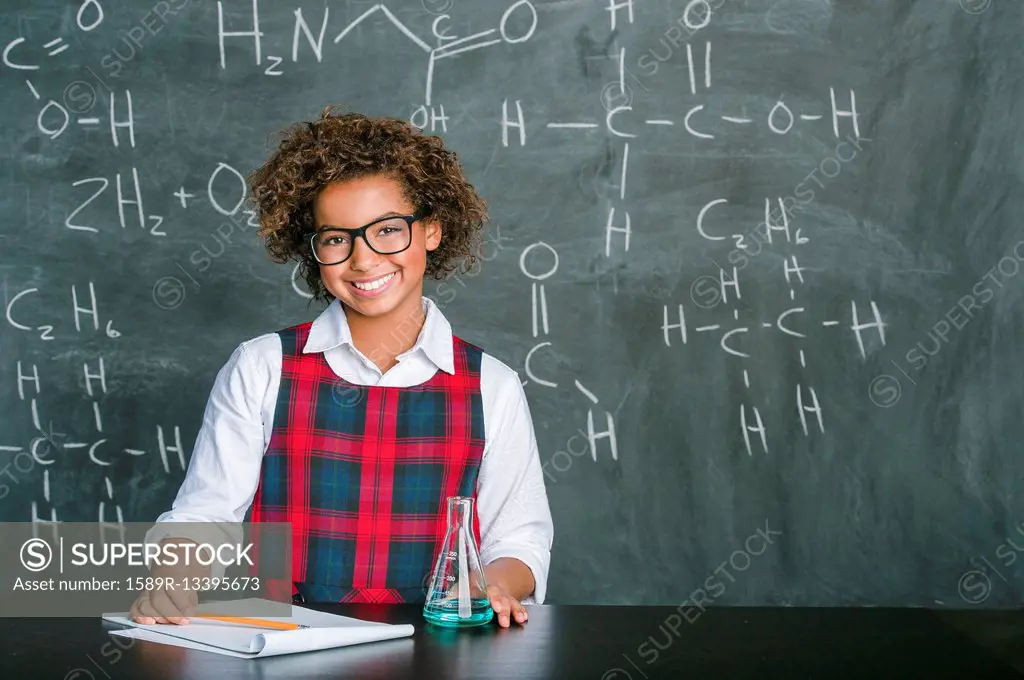 Mixed race student doing experiment in science class
