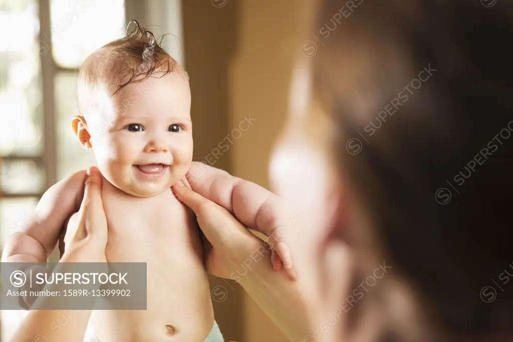 Caucasian mother bathing baby daughter