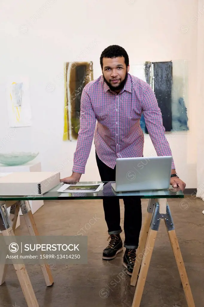 Mixed race man working in art gallery