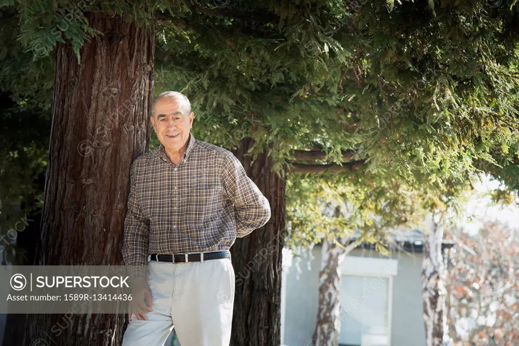 Hispanic man smiling outdoors