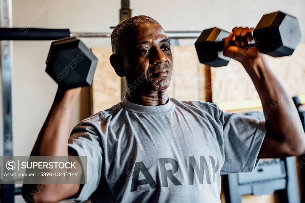 Black man lifting weights in garage