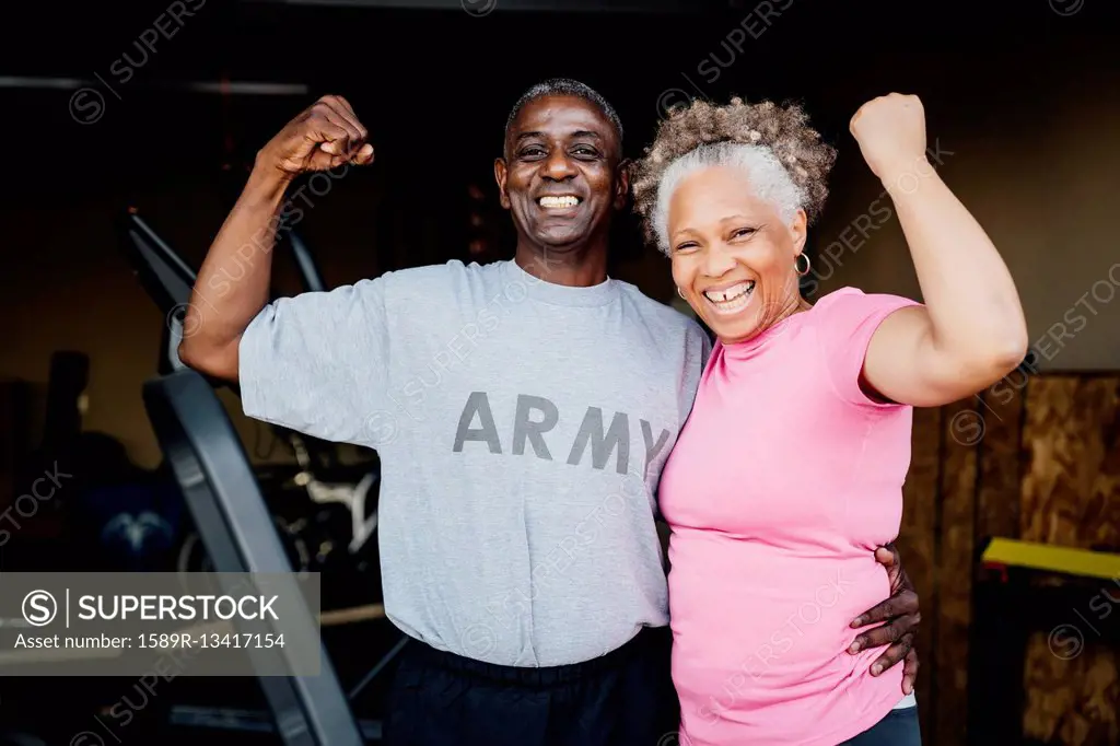 Black woman flexing muscles in garage