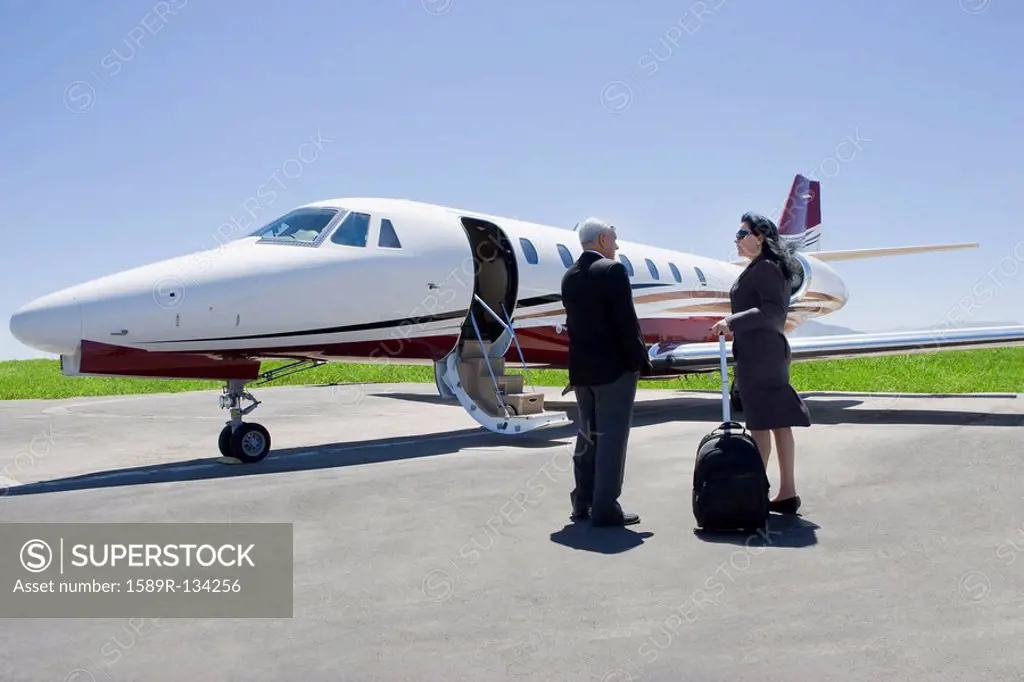 Business people boarding private jet
