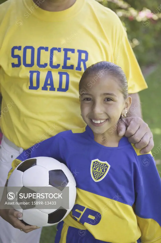Soccer girl posing with her father