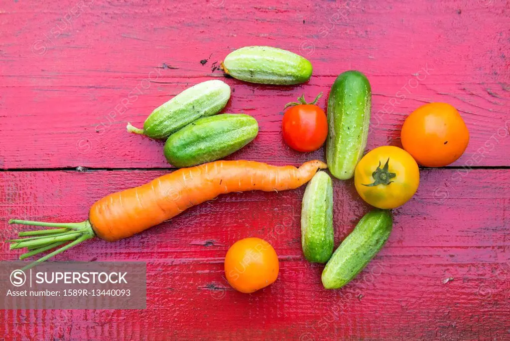 Close up of fresh vegetables on red wooden table