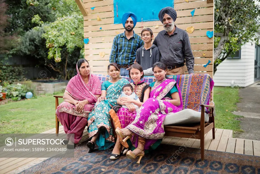 Multi-generation family posing on patio bench