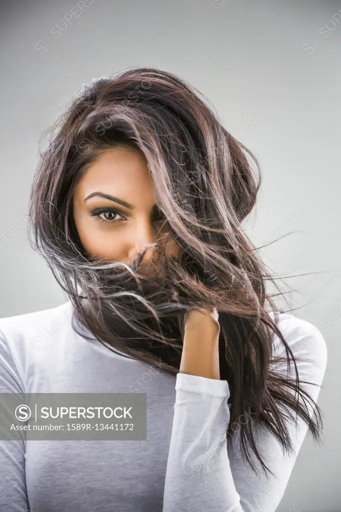 Hair blowing in face of Indian woman