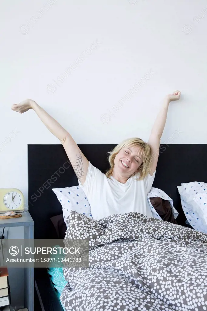 Caucasian woman waking in bed