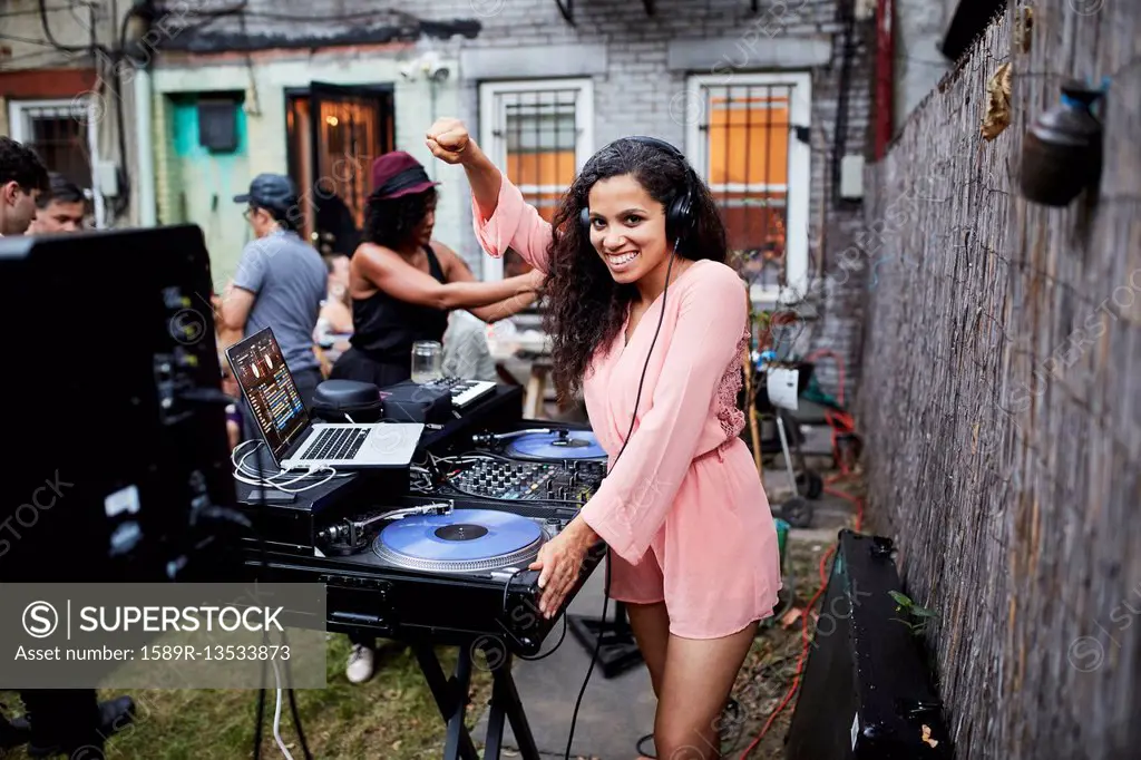 Woman playing music at party in backyard