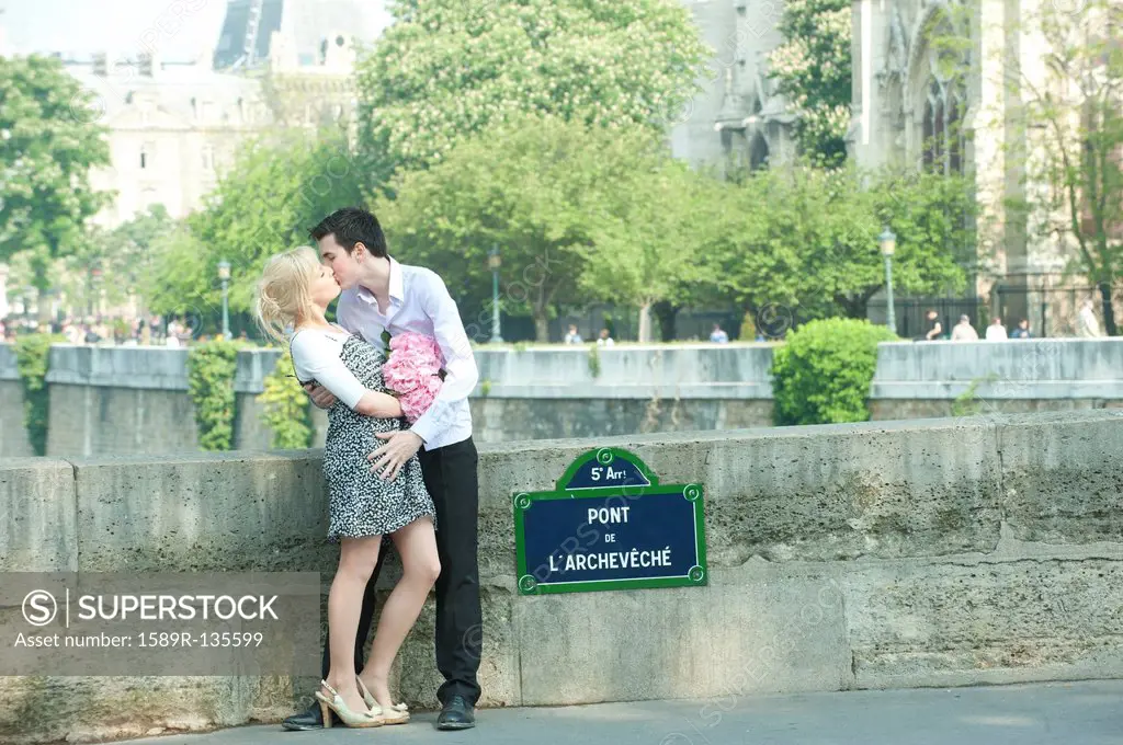 Caucasian couple kissing on Pont de L´Archeveche