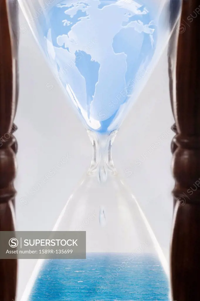 Globe squeezing through hour glass