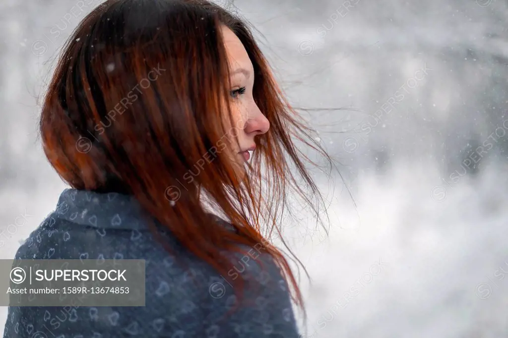 Hair of Caucasian woman blowing in wind in winter