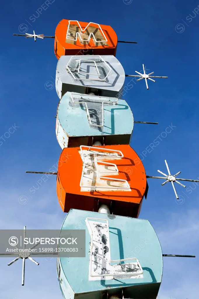 Old-fashioned motel sign under blue sky