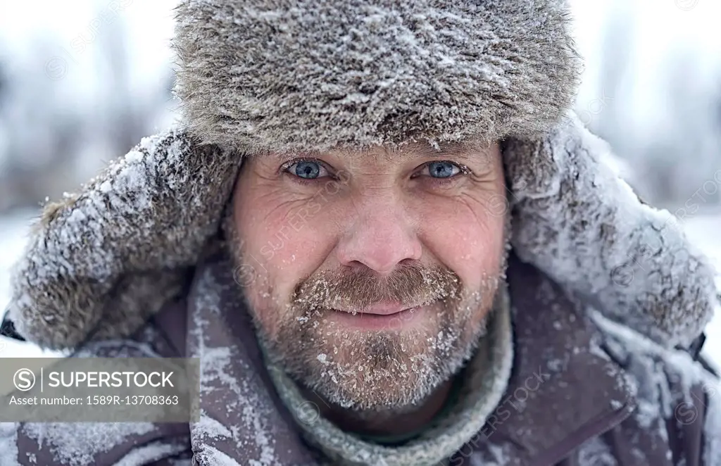 Portrait of Caucasian man with ice in bear in winter