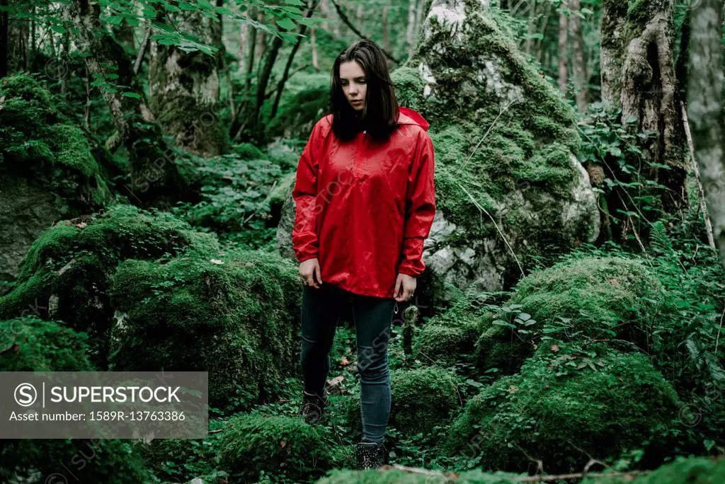 Caucasian woman standing in lush forest