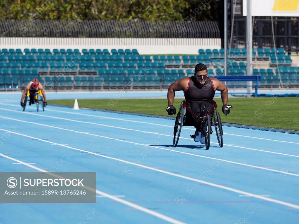 Middle Eastern man racing in wheelchair on track