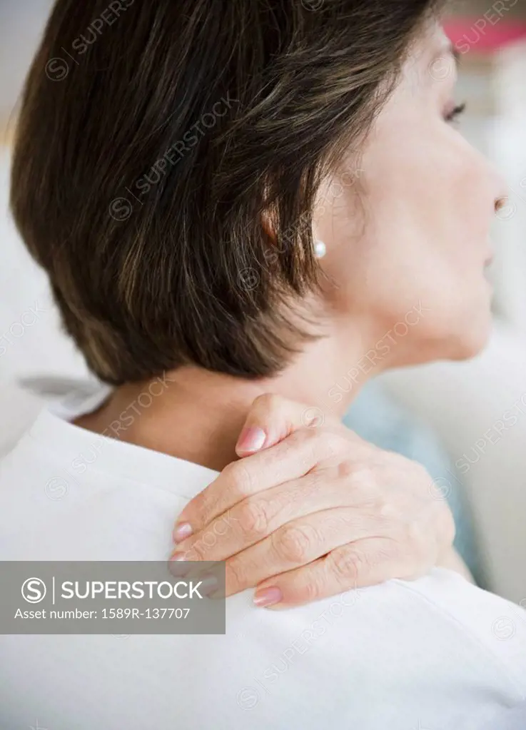 Japanese woman rubbing neck and shoulders