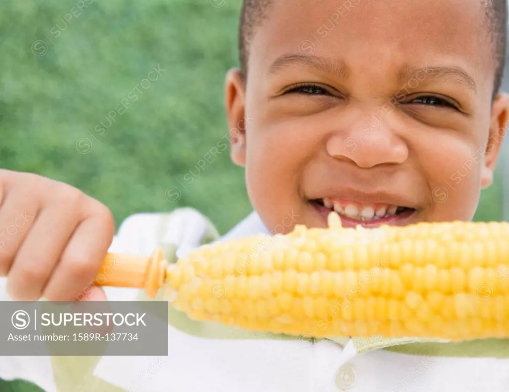 African American boy eating corn on the cob