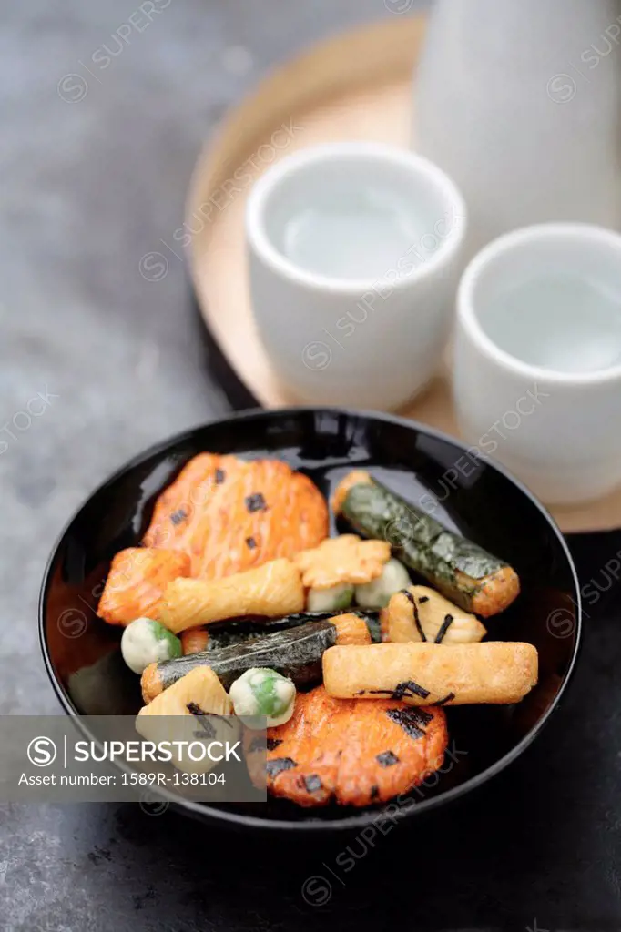 Close up of Japanese rice crackers and sake
