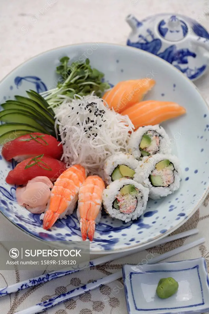 Variety of sushi rolls and sashimi in bowl