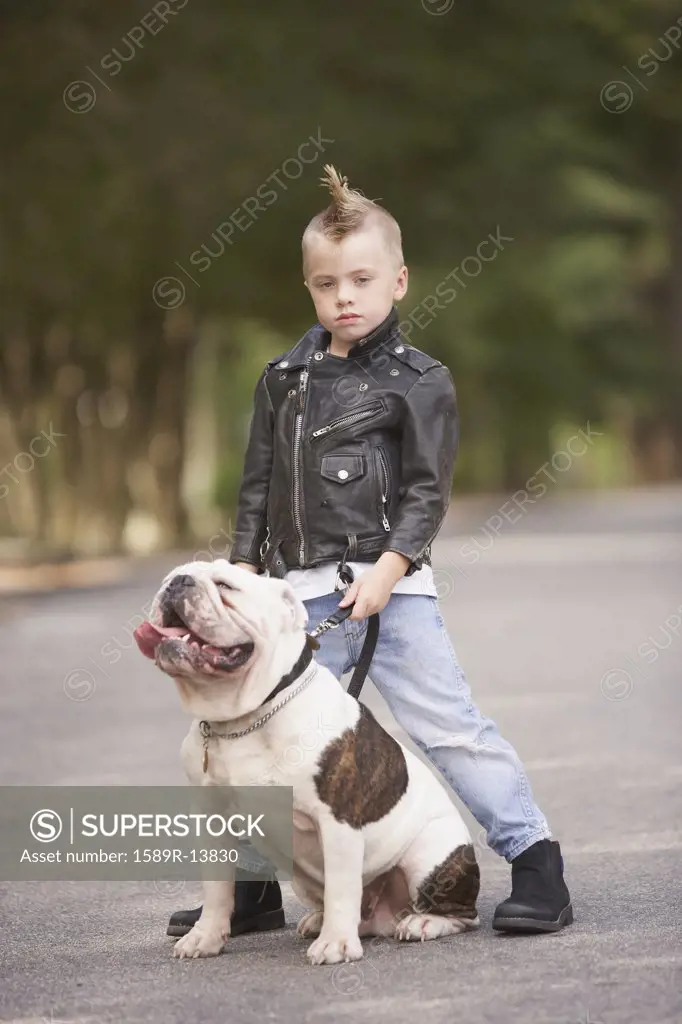 Portrait of boy with mohawk in leather jacket with bulldog