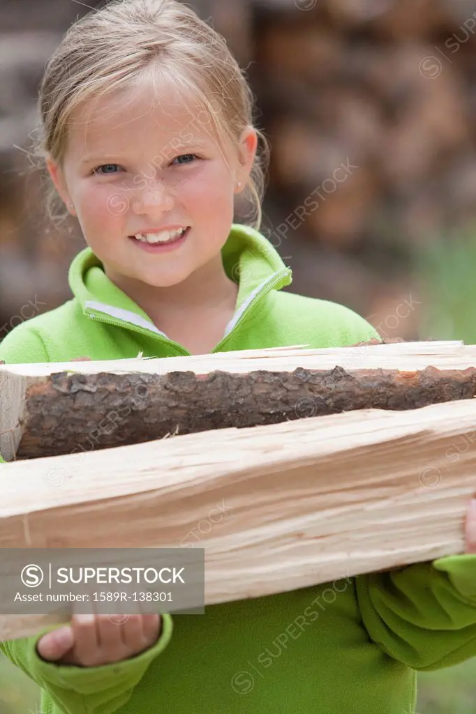 Caucasian girl carrying firewood