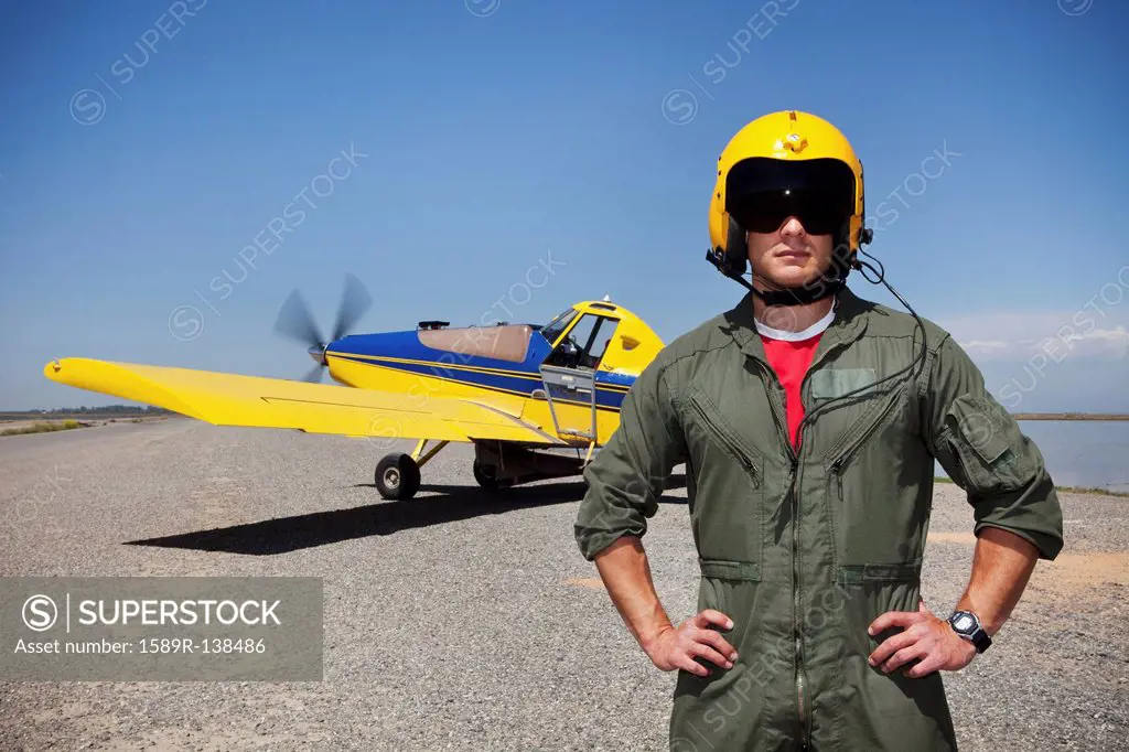 Pilot standing near small airplane