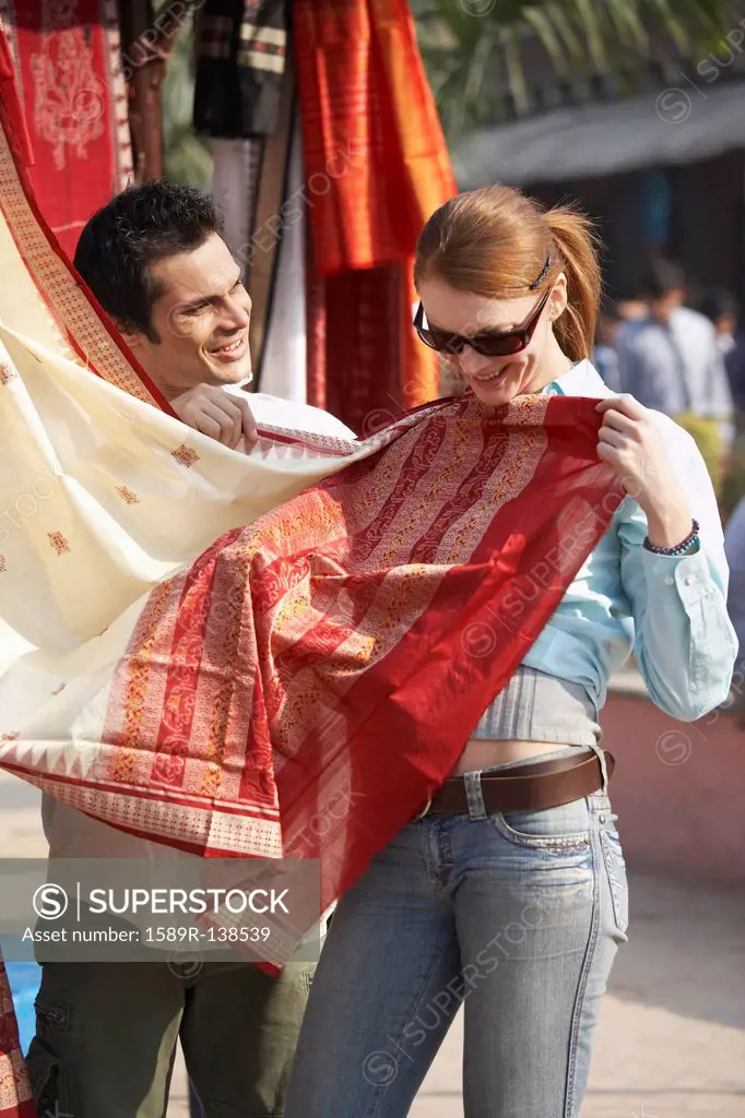 Customer looking at fabric in market