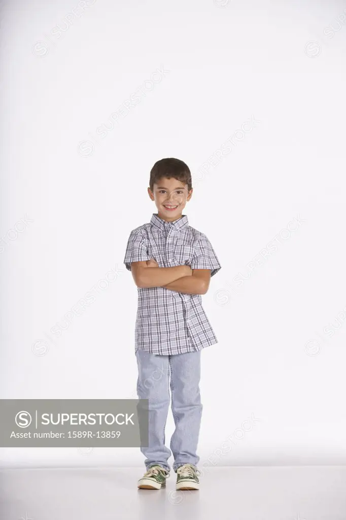 Portrait of boy standing with arms crossed