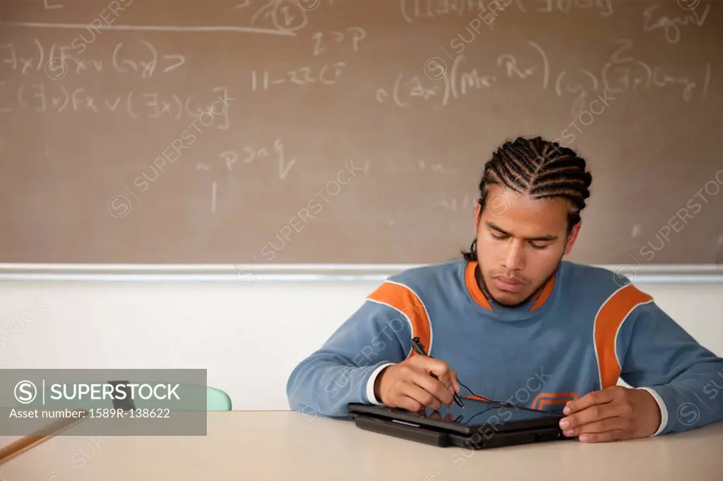 Peruvian student studying in classroom on laptop