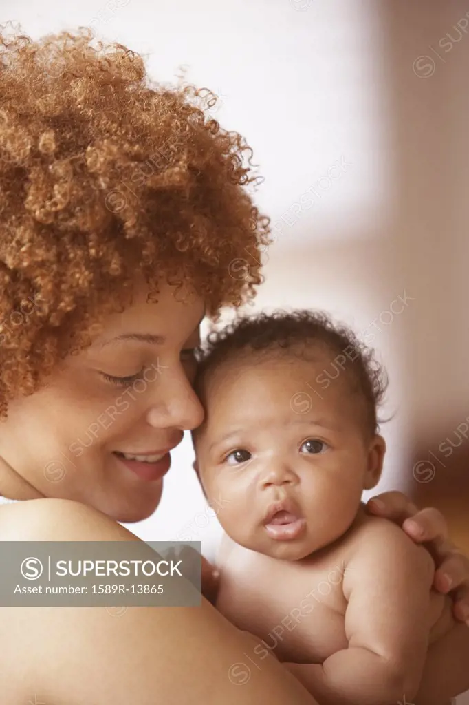 Portrait of mother holding baby on chest