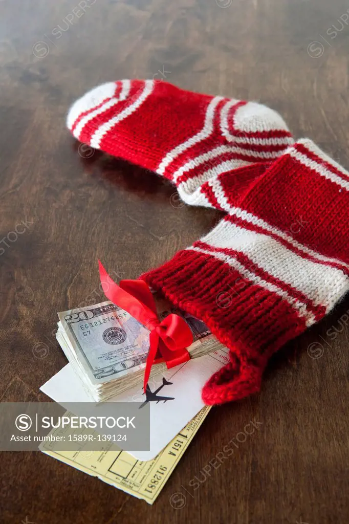 Christmas stocking with airline tickets and cash