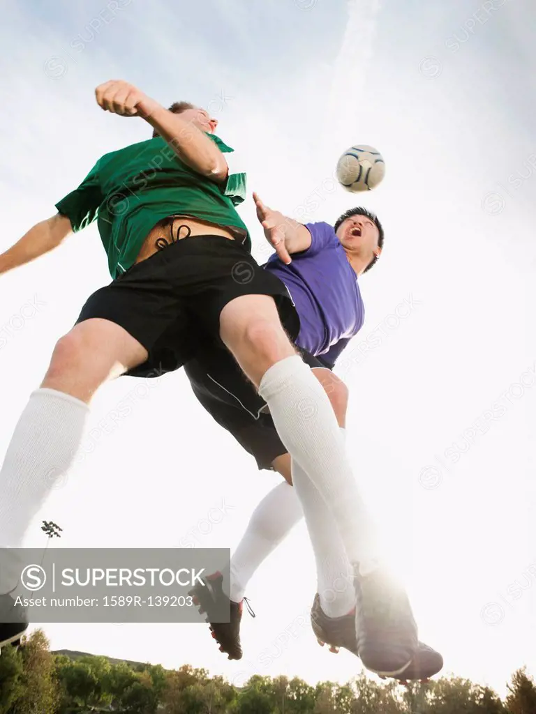 Soccer players heading soccer ball