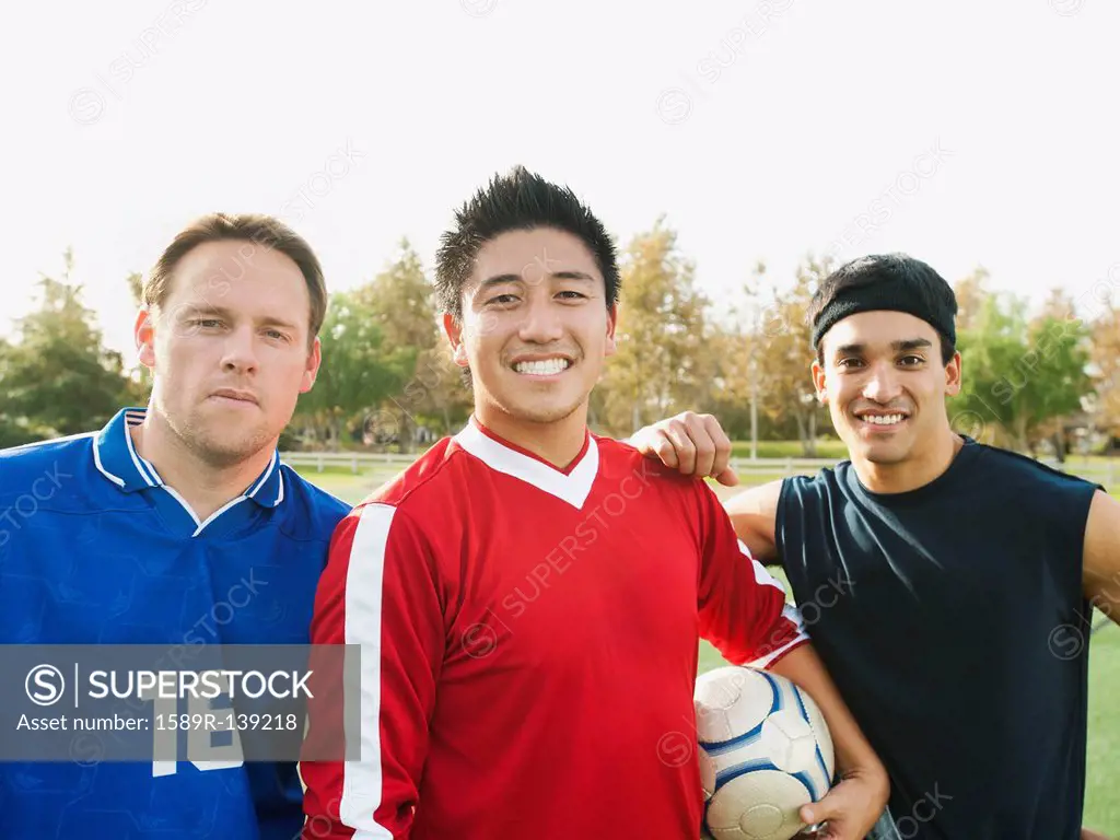Smiling soccer players with ball