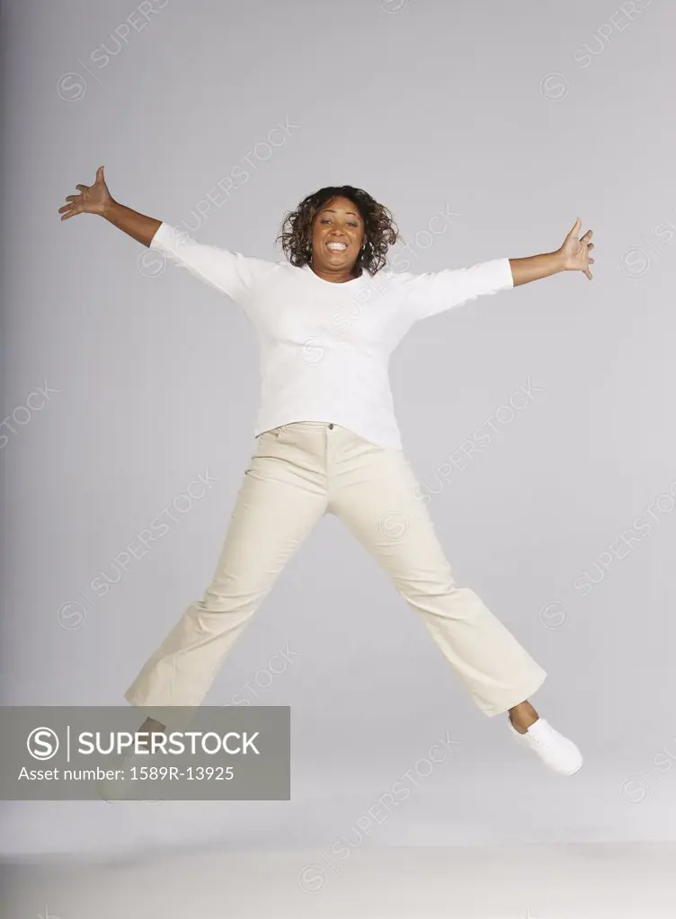 Portrait of woman jumping in air