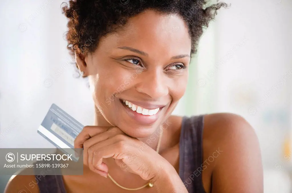 Black woman holding credit card